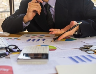 A person sitting at a table looking at charts