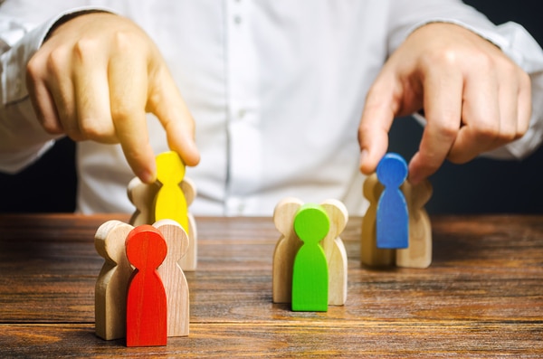 Person moving figurines on table